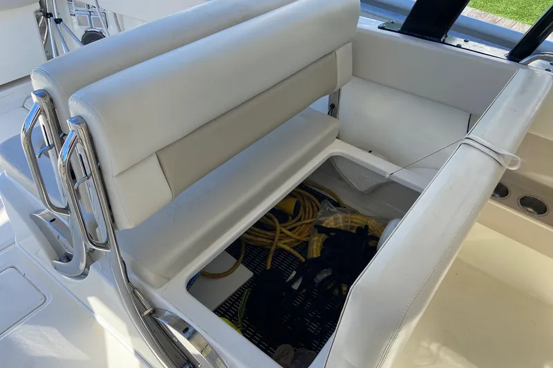 Slide: The Image of 2024 Boston Whaler 320 Vantage boat seat with storage compartment open. - 22