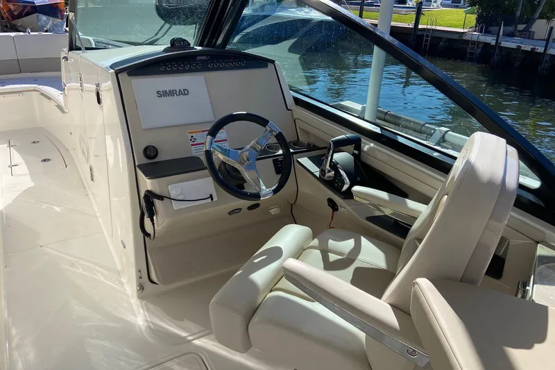 Slide: The Image of 2024 Boston Whaler 320 Vantage helm with Simrad display, luxurious seating, and modern controls. - 24