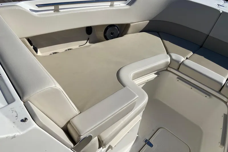 Slide: The Image of 2024 Boston Whaler 320 Vantage interior seating area with beige upholstery. - 30