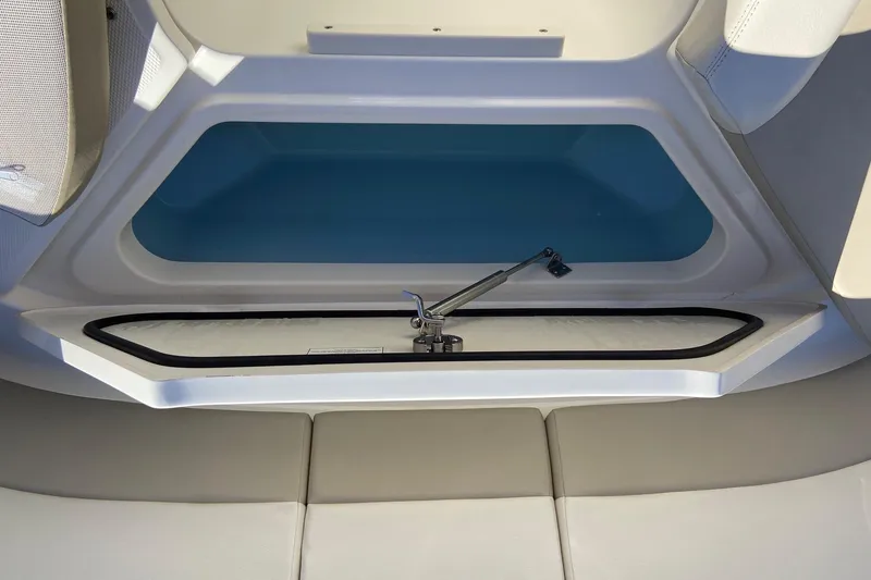 Slide: The Image of 2024 Boston Whaler 320 Vantage interior storage compartment with cushioned seating. - 32