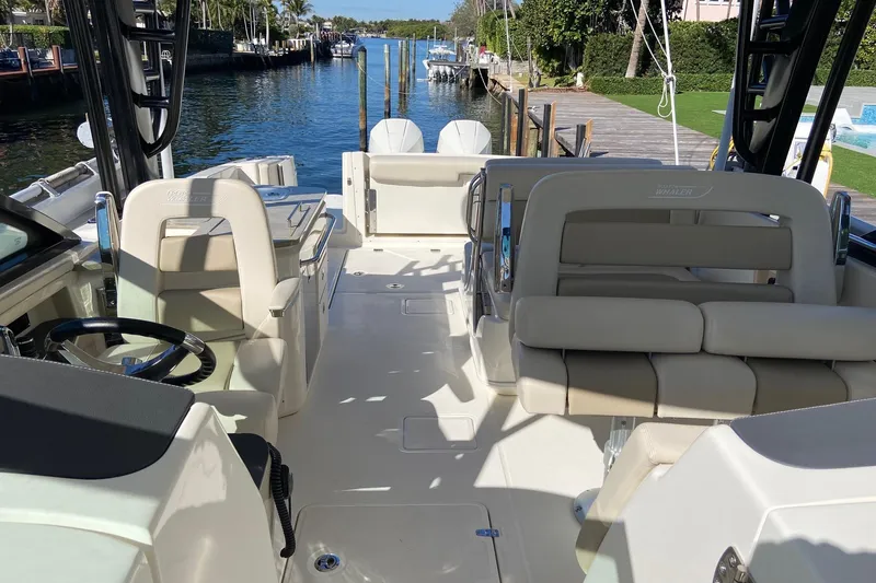 Slide: The Image of 2024 Boston Whaler 320 Vantage boat interior with luxurious seating and steering wheel. - 35