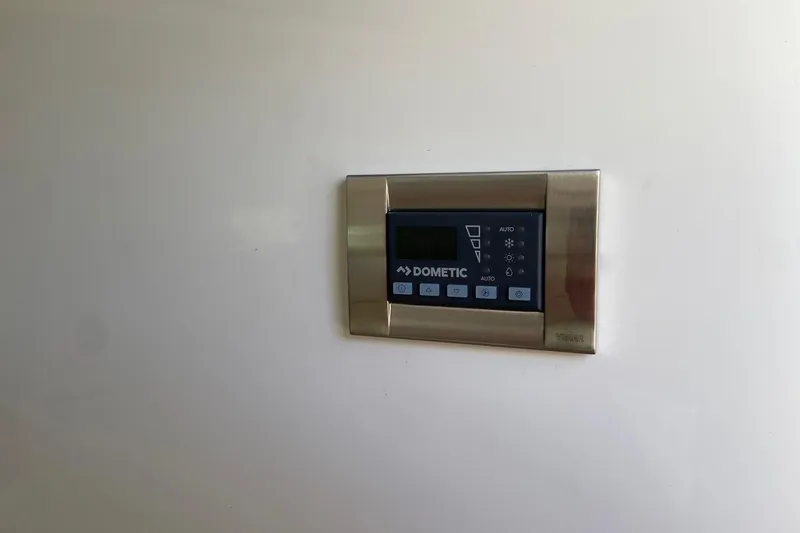 Slide: The Image of Dometic control panel on 2024 Boston Whaler 320 Vantage boat interior. - 39