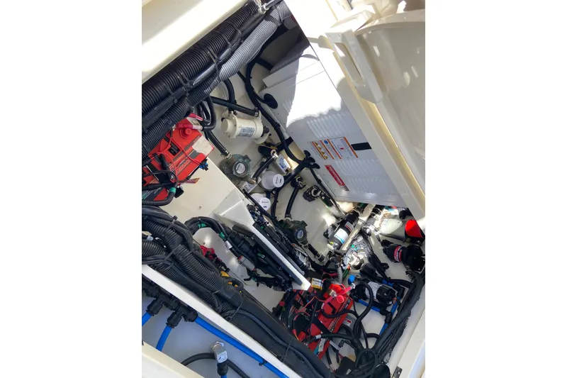 Slide: The Image of 2024 Boston Whaler 320 Vantage engine compartment with wiring and components. - 43