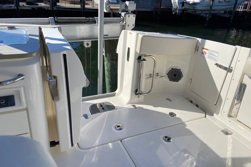 Slide: The Image of 2024 Boston Whaler 320 Vantage boat interior with open deck and storage compartments. - 5