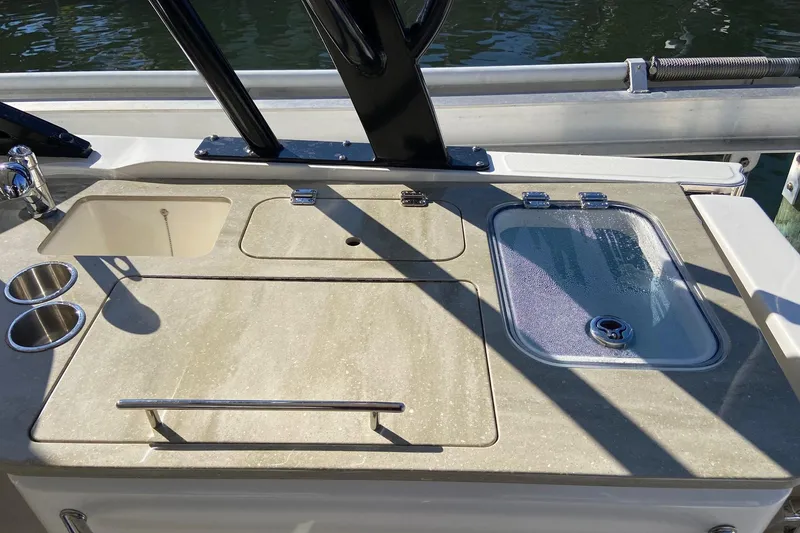 Slide: The Image of 2024 Boston Whaler 320 Vantage boat deck with sink and storage compartments. - 9