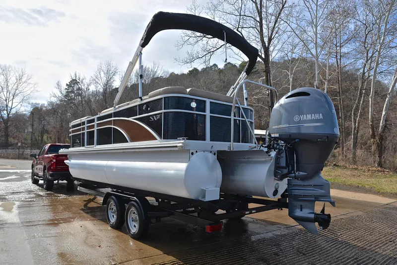 Slide: The Image of 2019 Bennington 21 SSX pontoon boat with Yamaha outboard motor on trailer. - 12