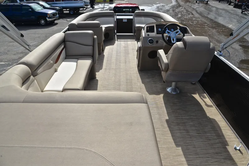 Slide: The Image of 2019 Bennington 21 SSX pontoon boat interior with beige seating and steering console. - 18