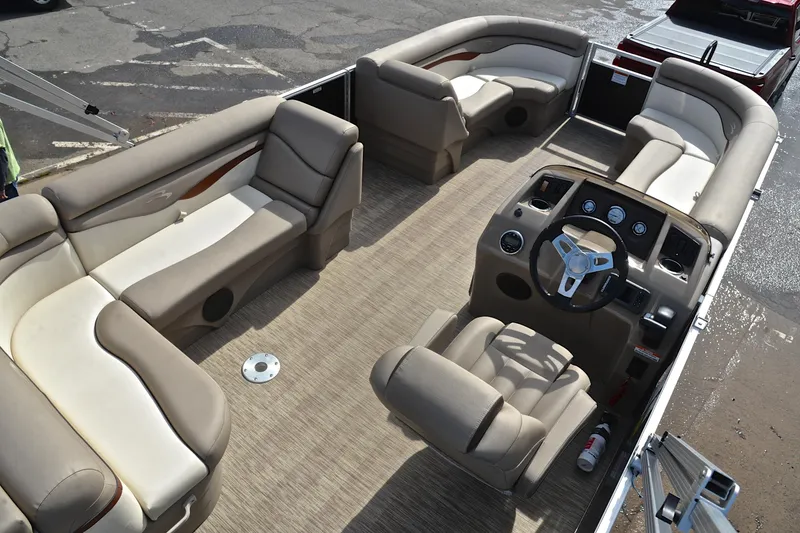 Slide: The Image of 2019 Bennington 21 SSX pontoon boat interior with beige seating and steering console. - 19