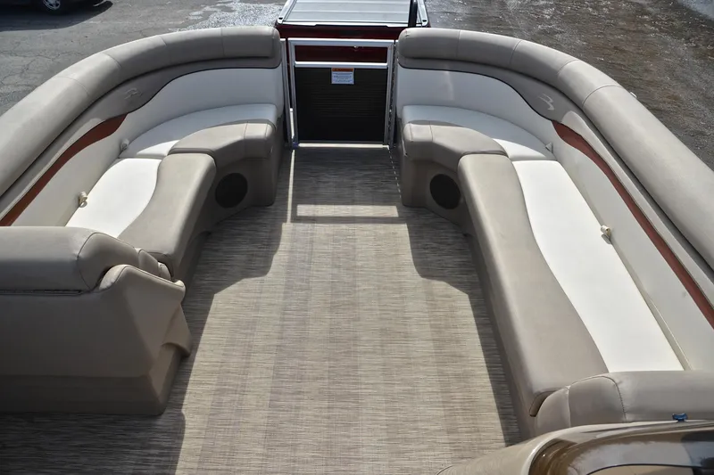 Slide: The Image of 2019 Bennington 21 SSX boat interior with beige seating and spacious layout. - 21