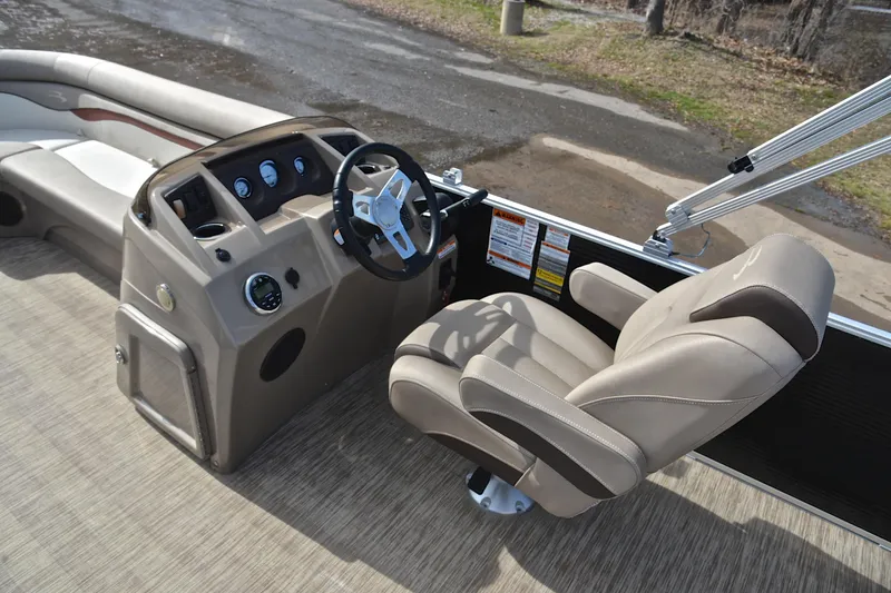 Slide: The Image of 2019 Bennington 21 SSX boat interior with steering wheel and captain's chair. - 24