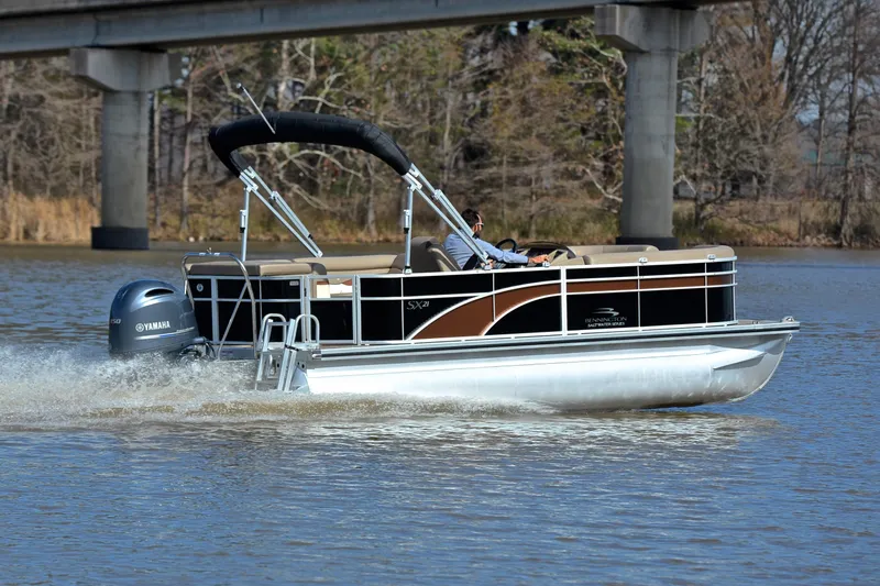 Slide: The Image of 2019 Bennington 21 SSX pontoon boat cruising on a river with Yamaha outboard motor. - 5