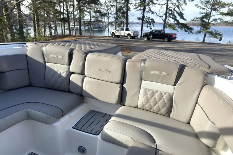 Slide: The Image of 2008 Sea Ray 270 SLX boat interior with luxurious seating near a scenic lake. - 18