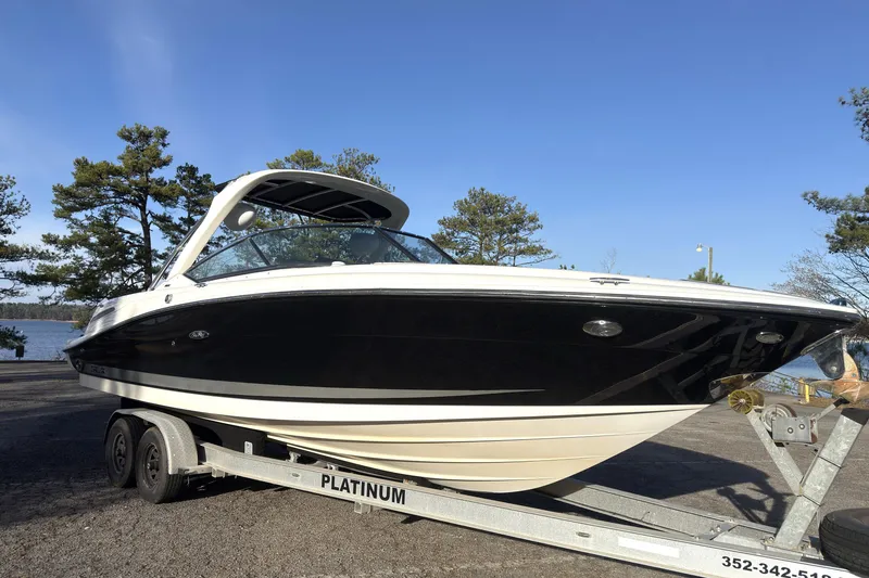 Slide: The Image of 2008 Sea Ray 270 SLX boat on trailer, parked near a lake with trees. - 3
