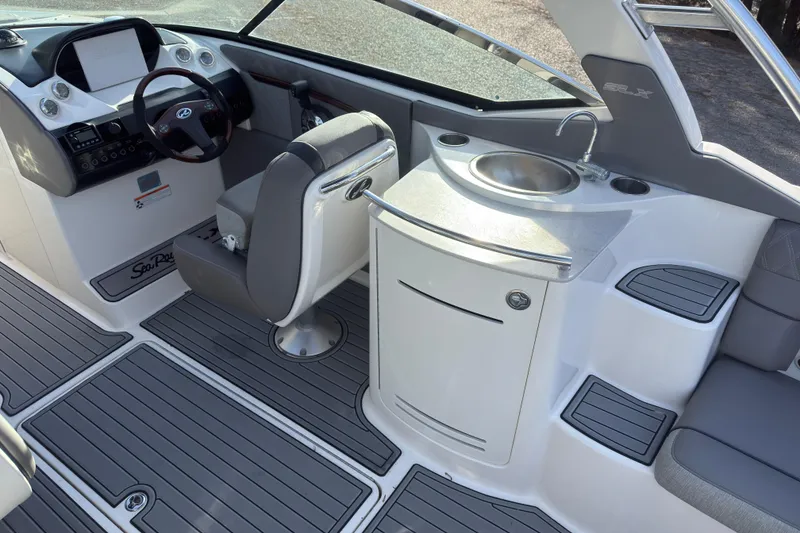 Slide: The Image of 2008 Sea Ray 270 SLX boat interior with helm, seating, and sink area. - 7