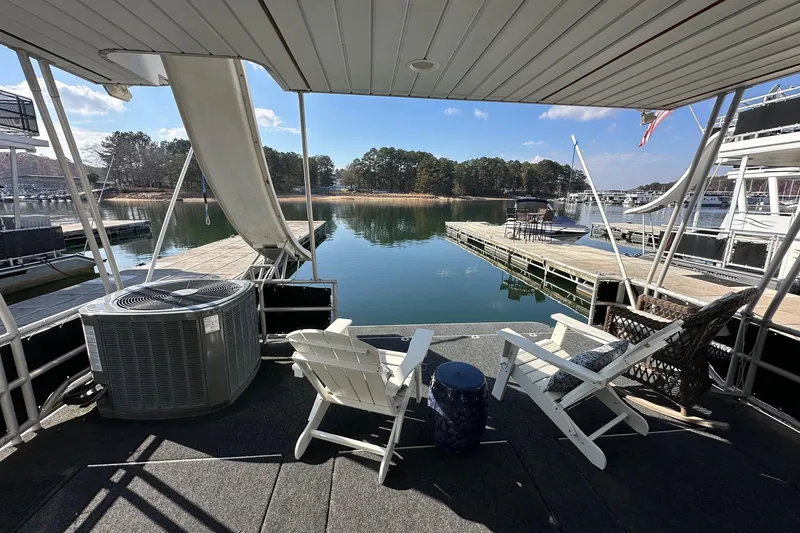 Slide: The Image of Houseboat deck with chairs overlooking serene lake and dock, Lakeview 16x68, 2004 model. - 13
