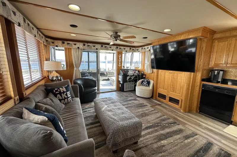 Slide: The Image of Luxurious 2004 Lakeview 16x68 houseboat interior with cozy living area and large TV. - 3