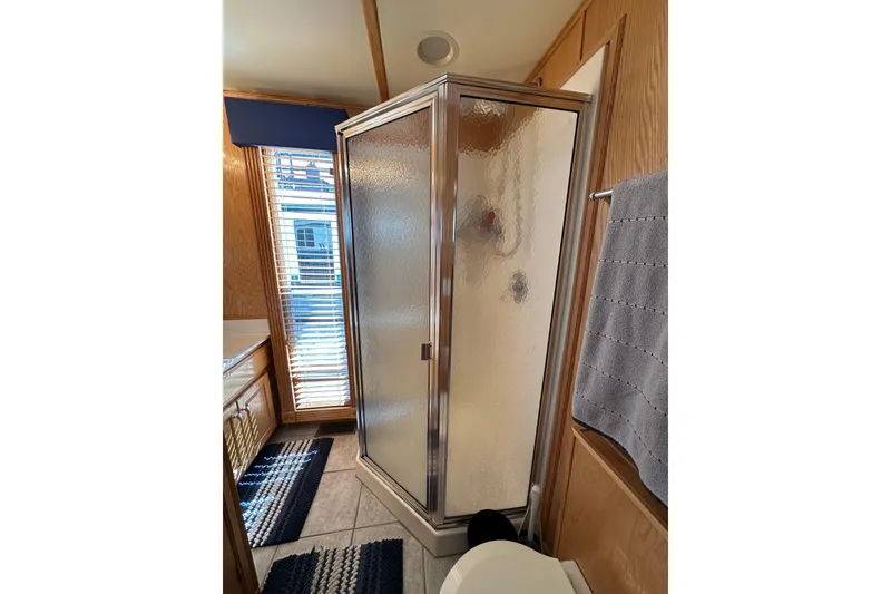 Slide: The Image of Compact bathroom with glass shower in 2004 Lakeview 16x68 model. - 9