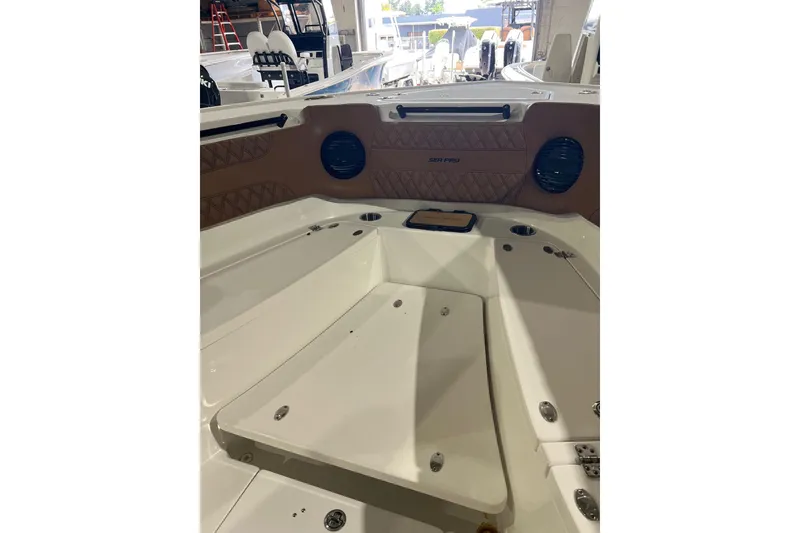 Slide: The Image of 2025 Sea Pro 322 Offshore boat interior with seating and storage compartments. - 10