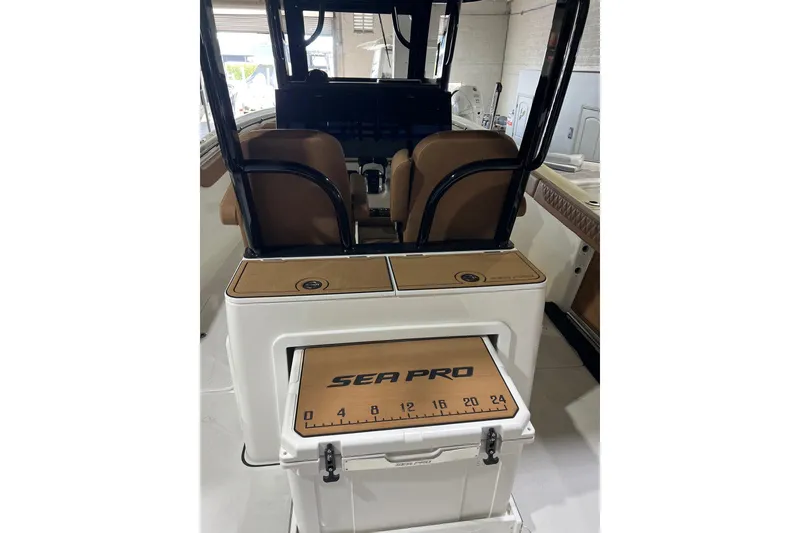 Slide: The Image of 2025 Sea Pro 322 Offshore boat interior with seating and storage area. - 12