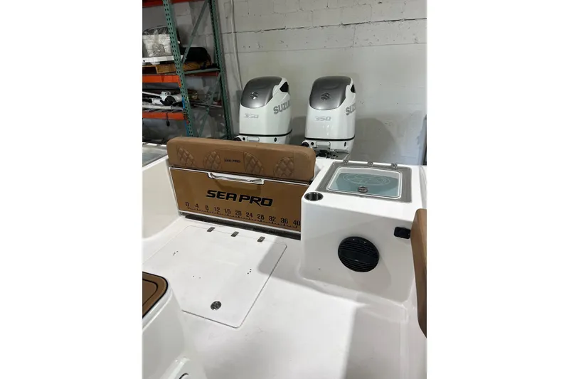 Slide: The Image of 2025 Sea Pro 322 Offshore boat interior with Suzuki engines in a warehouse setting. - 13