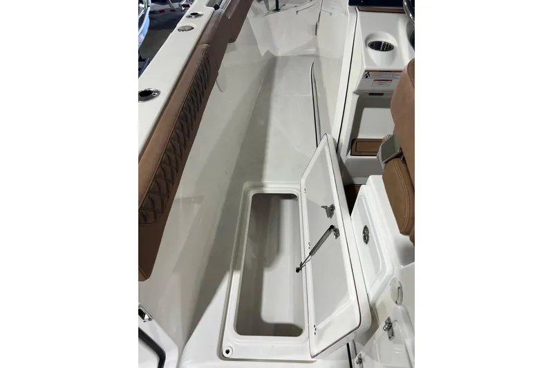Slide: The Image of 2025 Sea Pro 322 Offshore boat interior with open storage compartment and seating. - 14