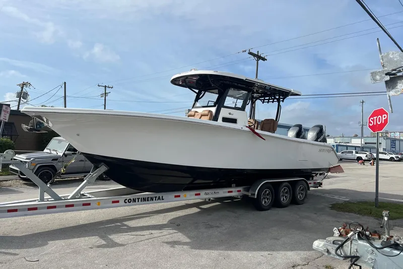 Slide: The Image of 2025 Sea Pro 322 Offshore boat on trailer, parked outdoors, clear sky background. - 2