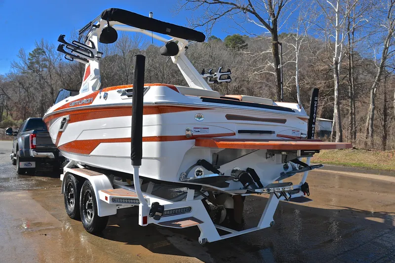 Slide: The Image of 2023 Centurion Ri230 boat on trailer, parked outdoors near trees. - 14