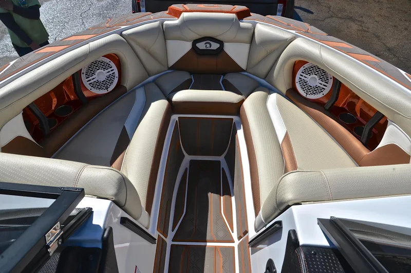 Slide: The Image of 2023 Centurion Ri230 boat interior with luxurious seating and built-in speakers. - 23