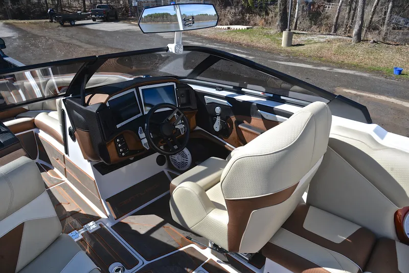 Slide: The Image of 2023 Centurion Ri230 boat interior with modern dashboard and steering wheel. - 27