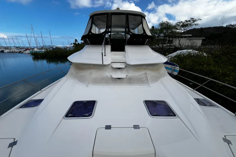 Slide: The Image of Aquila 44 yacht, 2016 model, docked by a marina under a blue sky. - 11