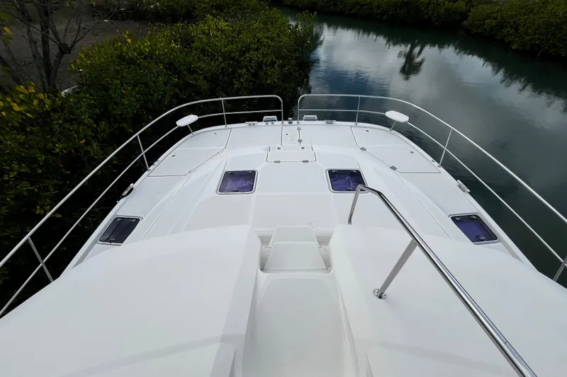 Slide: The Image of Aquila 44 yacht deck, 2016 model, overlooking serene waterway and lush greenery. - 12