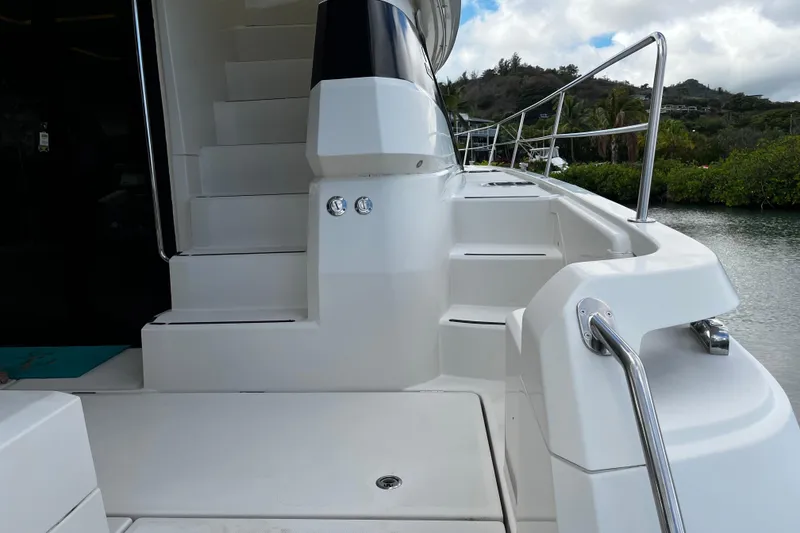 Slide: The Image of Staircase on 2016 Aquila 44 yacht, featuring sleek white design and stainless steel railings. - 14