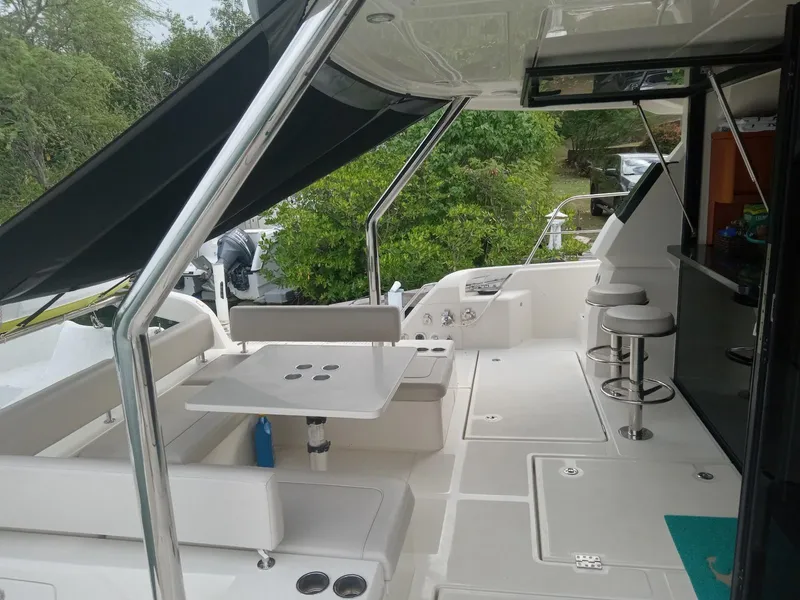 Slide: The Image of 2016 Aquila 44 yacht interior with seating and table, featuring sleek design and modern amenities. - 19