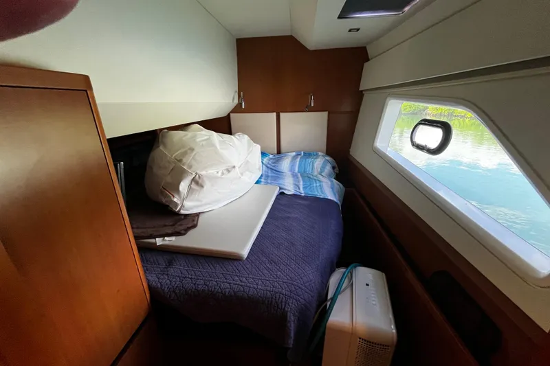 Slide: The Image of Cozy cabin interior of 2016 Aquila 44 yacht with bed and window view. - 29
