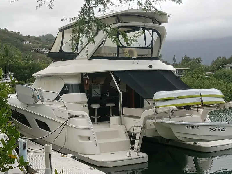 Slide: The Image of Luxury 2016 Aquila 44 yacht docked in a scenic marina setting. - 3