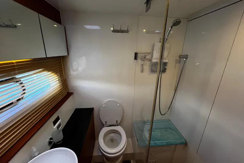 Slide: The Image of Modern bathroom in 2016 Aquila 44 yacht with shower, toilet, and window blinds. - 30