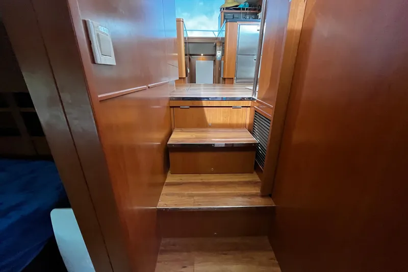 Slide: The Image of Interior wooden stairs on a 2016 Aquila 44 yacht, leading to upper deck. - 32