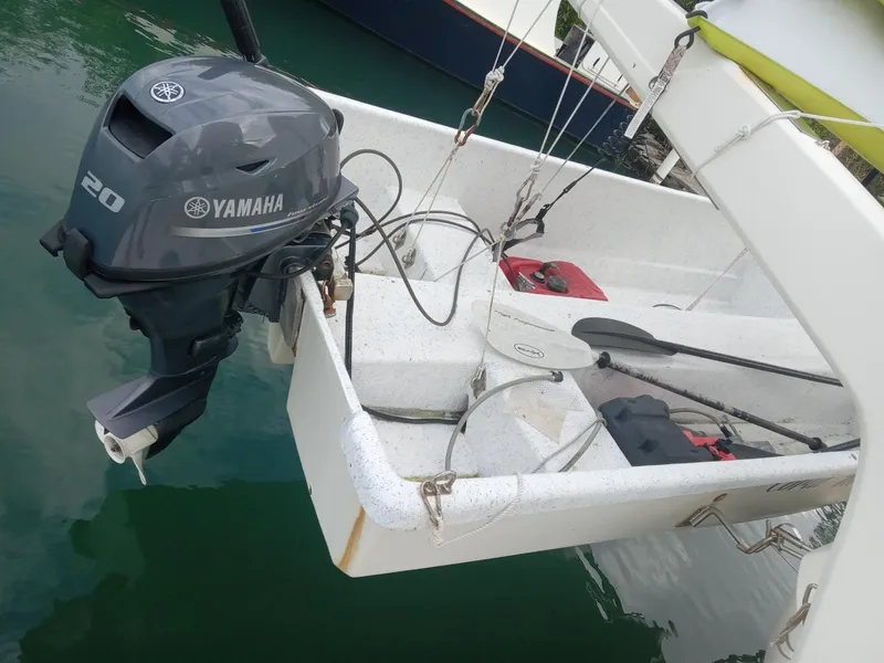 Slide: The Image of Aquila 44 boat with Yamaha 20 outboard motor, docked on calm water. - 37