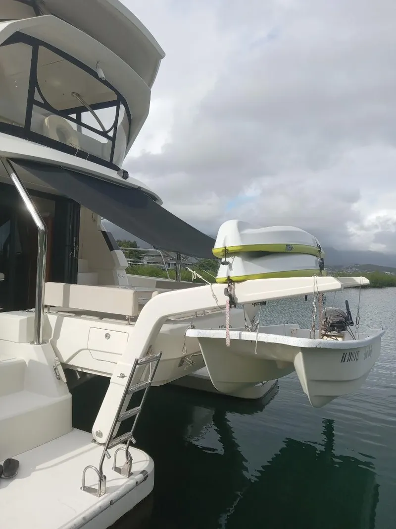 Slide: The Image of Aquila 44 yacht, 2016 model, docked with a small boat on davits. - 6