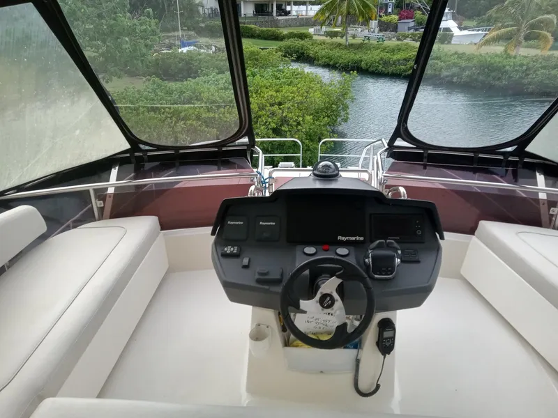Slide: The Image of Helm of 2016 Aquila 44 yacht with panoramic view and modern controls. - 8