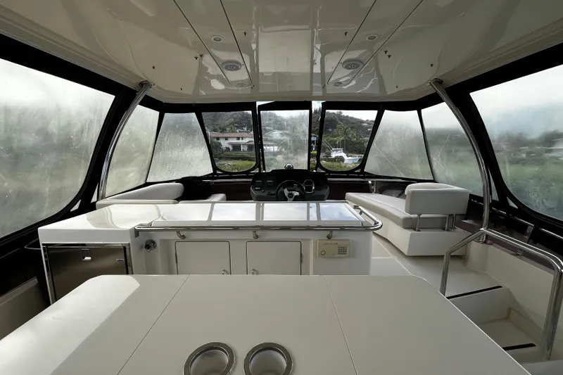 Slide: The Image of Interior of a 2016 Aquila 44 yacht with modern seating and panoramic windows. - 9