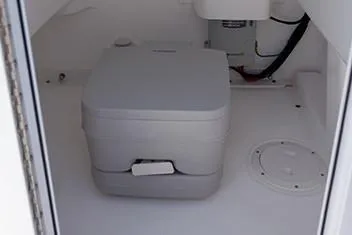 Slide: The Image of Manufacturer Provided Image: Portable toilet in 2020 Everglades 243 Center Console boat. - 16