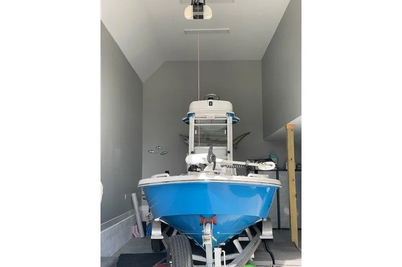 Slide: The Image of 2020 Everglades 243 Center Console boat in a garage, front view. - 18