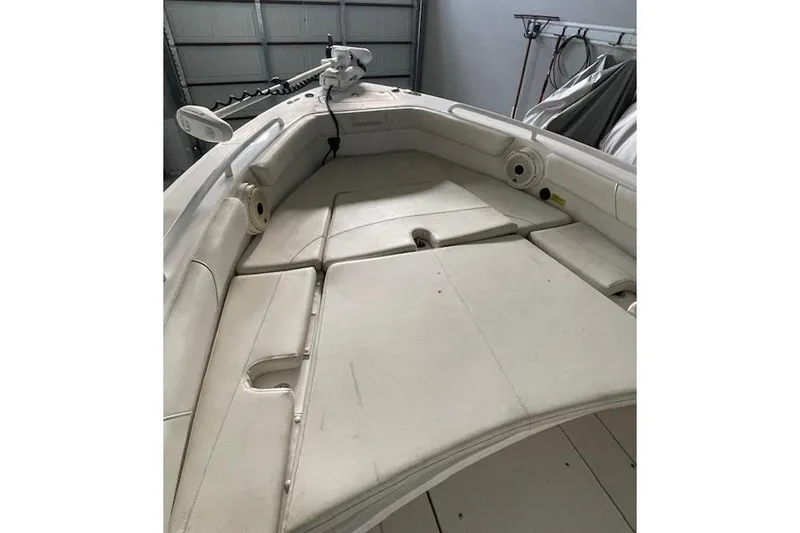 Slide: The Image of 2020 Everglades 243 Center Console boat interior with cushioned seating and storage compartments. - 21