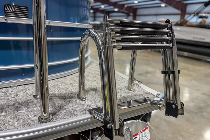 Slide: The Image of 2025 Trifecta 22 RF LE pontoon boat with stainless steel ladder and blue exterior. - 5