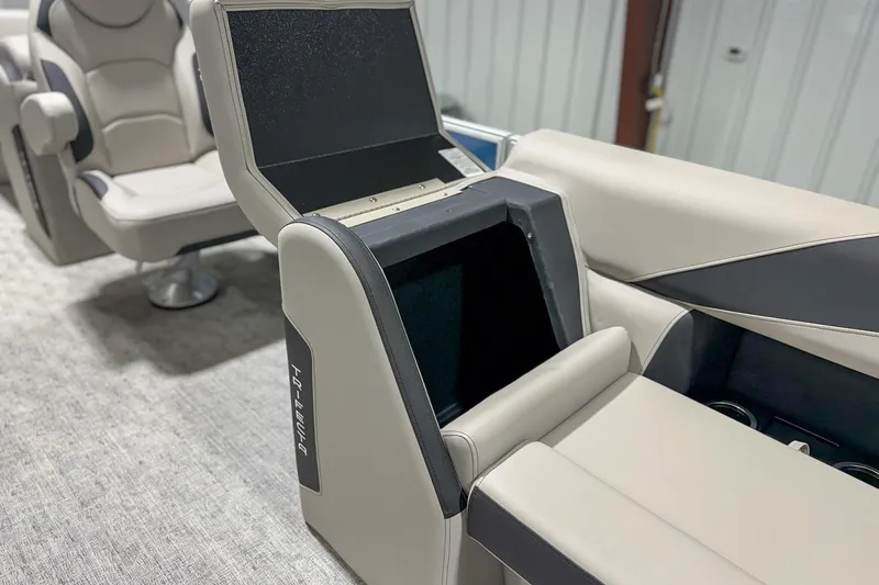 Slide: The Image of 2025 Trifecta 22 RF LE boat interior with open storage compartment and seating. - 9