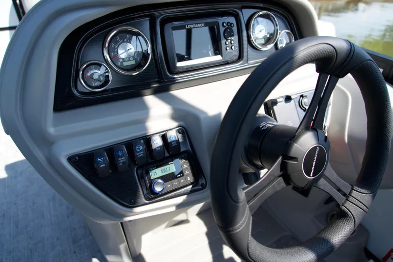 Slide: The Image of Steering console of 2026 Berkshire 22 RFX LE boat with gauges and controls. - 11