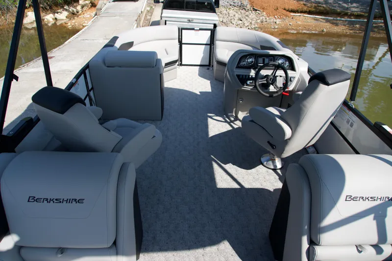 Slide: The Image of 2026 Berkshire 22 RFX LE pontoon boat interior with plush seating and modern dashboard. - 13