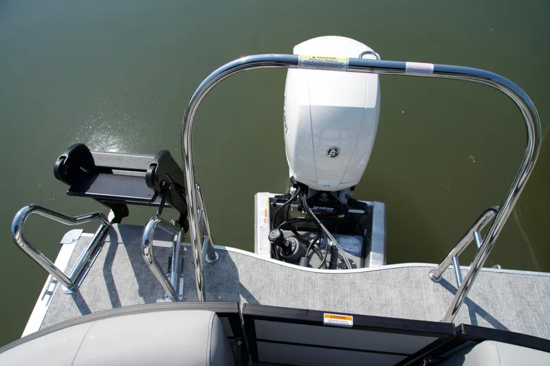 Slide: The Image of 2026 Berkshire 22 RFX LE boat with outboard motor and swim platform on calm water. - 14