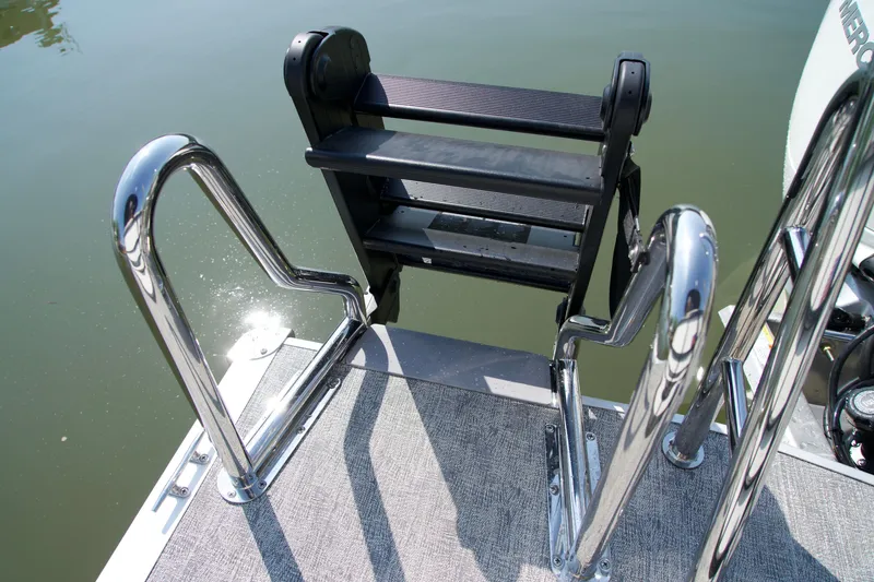 Slide: The Image of Stainless steel boat ladder on 2026 Berkshire 22 RFX LE pontoon, reflecting sunlight on water. - 15